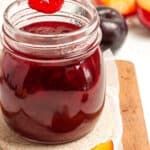 a jar filled with fruit sitting on top of a cutting board