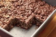 a pan filled with chocolate granola bars on top of a wooden table