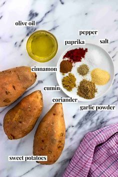 ingredients to make sweet potatoes laid out on a white marble counter top, including turment, pepper, cinnamon, cumin and garlic powder