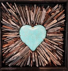 a blue heart is surrounded by sticks and wood