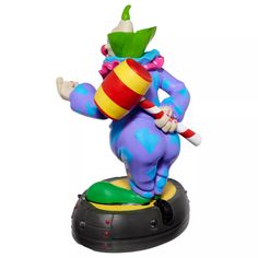 a toy figurine that is on top of a base with a hat and cane