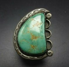 "VINTAGE NAVAJO RING DESCRIPTION: A huge specimen of natural Royston turquoise set in a heavy gauge hand-stamped frame. This ring will be a treasured addition to your collection of fine vintage Native American jewelry. MEASUREMENTS: Ring face measures 1 3/8\" x 1\" Cabochon measures 26mm x 17mm RING SIZE: 5 1/2 WEIGHT: 12.5 grams SIGNED: no STERLING: unmarked, verified sterling silver" Antique Untreated Turquoise Jewelry, Vintage Green Turquoise Cabochon Ring, Vintage Emerald Cabochon Ring Collectible, Antique Stamped Turquoise Jewelry, Vintage Turquoise Stamped Jewelry, Vintage Stamped Turquoise Jewelry, Vintage Rings With Large Stone For Collectors, Vintage Rings With Large Stone For Collectible, Vintage Oval Untreated Emerald Ring