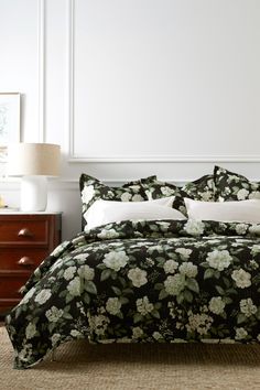 a bed with black and white flowers on it