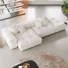 a large white couch sitting on top of a living room floor