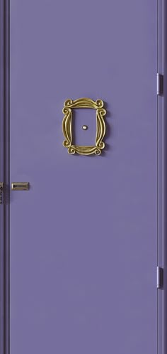 a purple door with a gold handle on it