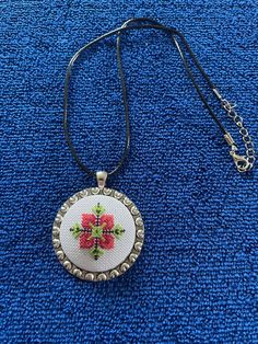 A handmade necklace with a traditional Bulgarian floral pattern. It's made from the hands of a master embroiderer with over 30 years of experience in the creation of tapestries.  Materials used: multi-coloured threads; metal base; polyester cord Size: 45x45mm Price list: (Listed prices include shipping costs) UK - £30 (Royal Mail 1st Class) International - £38.85 (Royal Mail Track & Sign) Multicolor Bohemian Embroidered Necklace, Multicolor Embroidered Bohemian Necklace, Multicolor Embroidered Bohemian Necklaces, Artisan Embroidered Necklaces For Festivals, Handmade Bohemian Multicolor Embroidery Jewelry, Folk Style Handmade Jewelry As Gift, Handmade Folk Style Jewelry Gift, Handmade Folk Jewelry As Gift, Bohemian Embroidered Beaded Necklaces As Gift