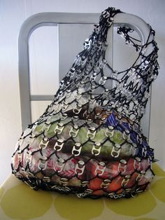 a bag sitting on top of a chair covered in plastic wrap and chainmails