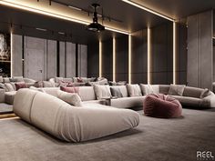 a living room filled with lots of couches and pillows on top of carpeted flooring