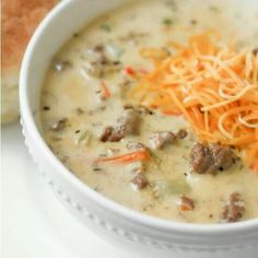 a white bowl filled with soup and cheese