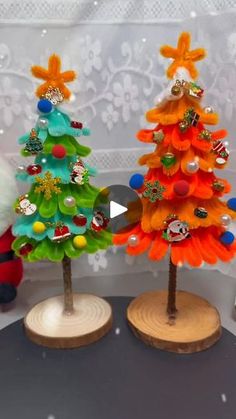 two small christmas trees on wooden bases