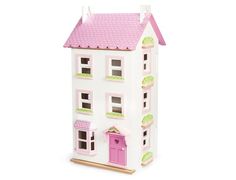 a toy doll house with pink and white trimmings on the roof, windows, and doors