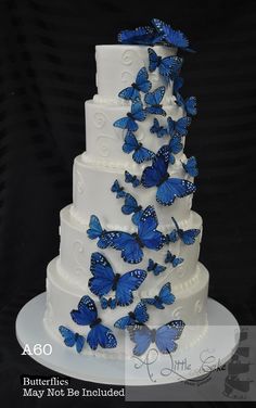 a wedding cake with blue butterflies on it