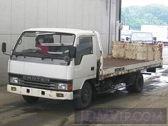 a white truck parked in front of a building