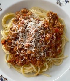 a white bowl filled with spaghetti and sauce