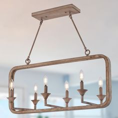 a chandelier with five candles hanging from it