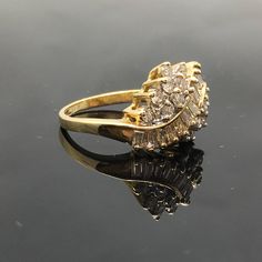 14K Diamond Cluster Ring METAL: 14K Yellow Gold TOTAL WEIGHT: 4.1g DIAMONDS: Round Brilliant Cut and Baguette Diamonds COLOR: H/I CLARITY: SI1 TOTAL WEIGHT: 1.00 ct SIZE: Ladies size 5-9. Please indicate your ring size at checkout. DESCRIPTION: Vintage style diamond cluster ring. The ring is yellow gold with round and baguette diamonds. The top width is 11.8mm and a height of 6.2mm. Statement Rings Diamond, Moonstone Engagement, Moonstone Engagement Ring, Baguette Diamonds, Ring Metal, Diamond Cluster Ring, Ring Diamond, Rings Simple, Baguette Diamond