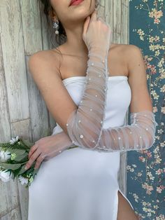 a woman in a white dress and gloves