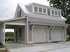 a two car garage with an attached porch