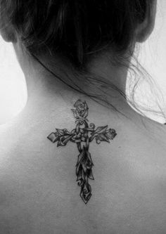 a woman with a cross tattoo on her back