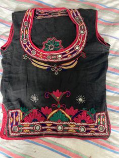 beautiful hand embroidered traditional Indian top . measures pit to pit 18 inches , length 20 inches ,waist 16 inches . Bohemian Tops With Intricate Embroidery For Navratri, Traditional Tops With Intricate Embroidery For Navratri, Festive Cotton Tops With Embroidered Border, Navratri Festival Choli With Floral Embroidery, Traditional Sleeveless Top With Intricate Embroidery, Bohemian Tops With Resham Embroidery For Festive, Bohemian Tops With Multicolor Embroidery For Navratri, Traditional Sleeveless Tops With Mirror Work, Bohemian Tops With Floral Embroidery For Navratri