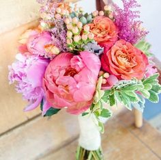 a vase filled with pink flowers on top of a table