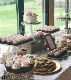 a table topped with lots of cakes and cupcakes