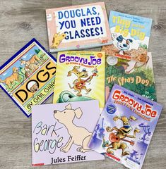 five children's books sitting on top of a wooden table next to each other