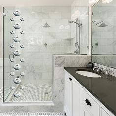 a bathroom with marble and black counter tops