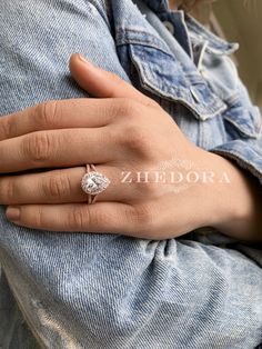 a woman's hand with a diamond ring on it