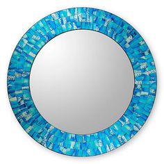 a round mirror with blue beads on it