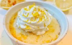 a bowl filled with lemon custard and whipped cream