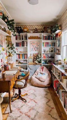 a room filled with lots of books on shelves next to a desk and chair in front of a window