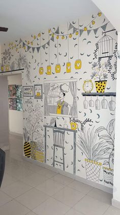 the wall is decorated with yellow and gray designs on it, along with hanging decorations