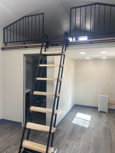 an empty room with stairs leading up to the second floor