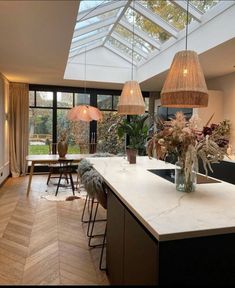 a kitchen with an island and skylight above it