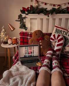 a person laying in bed with their feet up on a laptop