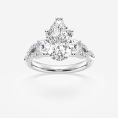 a pear shaped diamond engagement ring on a white background