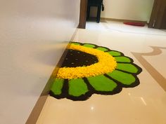 the floor is decorated with yellow flowers and green leafy petals on top of it