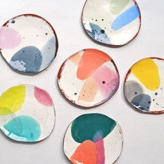 six plates with different colors and shapes on them