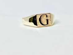 On display is a gold monogram ring available in 10K, 14K. Customizable embossed or laser inscription -  just message for specifics (font, symbol etc) Monogram Ring Gold, Monogram Ring, Signet Rings, Gold Monogram, Signet Ring, On Display, Gold Bands, Etsy App, Selling On Etsy