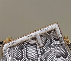 a white and black snake skin purse