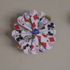 a clock made out of playing cards on a wall