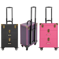 three different colored suitcases on wheels with handles and handlebars, one in black, the other in pink