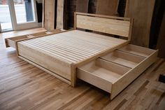 a bed that has drawers in it on the floor