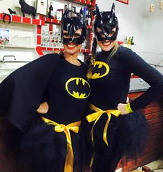 two women dressed up as batman and catwoman posing for a photo in their costumes