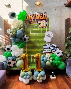 balloons are arranged in the shape of numbers for a soccer themed birthday party at an indoor venue