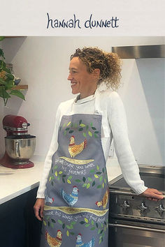 a woman in an apron standing next to a stove top oven with the words hannah dunnet on it