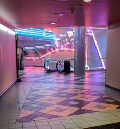 an empty room with checkered floor and neon lights