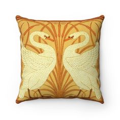 a decorative pillow with two swans on it's sides and an art nouveau design