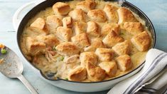 a casserole dish with chicken and cheese in it on a blue wooden table